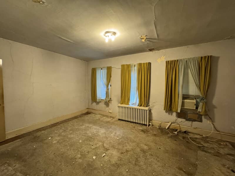 Upper-level bedroom with large windows, radiator, and yellow curtains at 909 Jackson Street NE in Washington DC.
