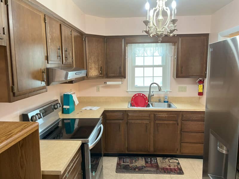 Traditional kitchen with wood cabinetry, stainless steel appliances, and a window above the sink at 7024 Sollers Point Road in Dundalk, MD.