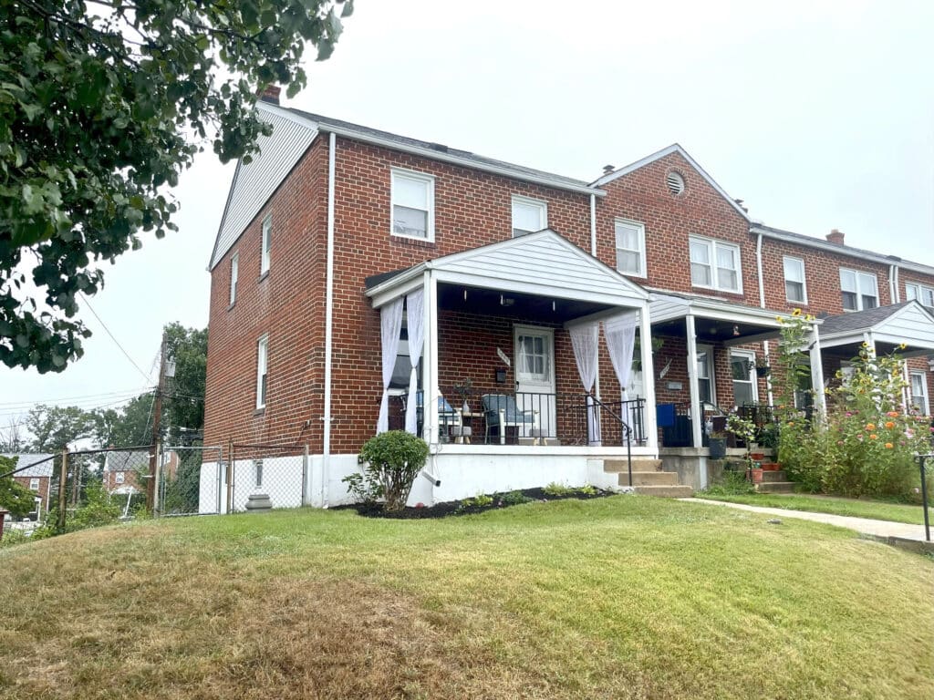 Brick end-of-group townhome with covered front porch at 1000 Downton Road, Arbutus.