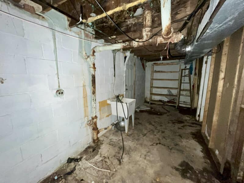 Basement utility sink and exposed mechanicals at 4902 Gilray Drive.
