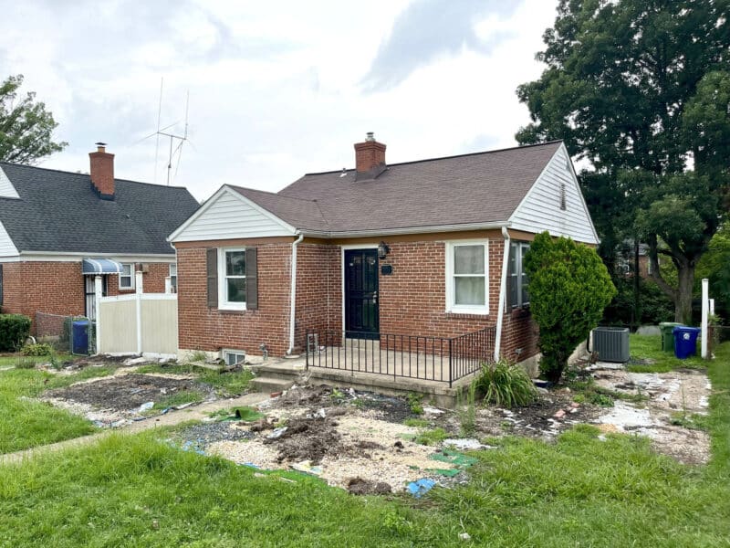 Front exterior of brick ranch-style home at 4902 Gilray Drive with fenced yard and front porch.