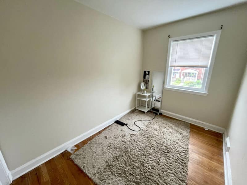 Small second bedroom with hardwood floors, neutral painted walls, and a window providing natural light at 1000 Downton Road, Arbutus.