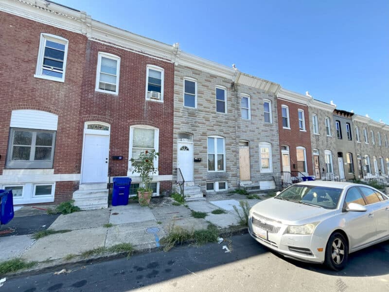 Angled exterior view of two-story brick townhome at 2115 E. Federal Street in Broadway East, Baltimore.