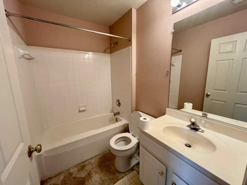 Full bathroom with tub/shower combo, vanity, and toilet.