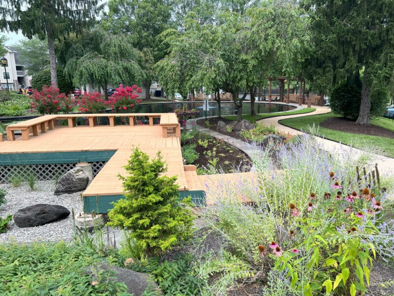 Beautifully landscaped community garden with ornamental ponds, walking paths, and lush greenery.