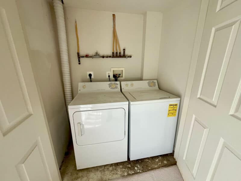 Laundry area with side-by-side washer and dryer in a utility closet.