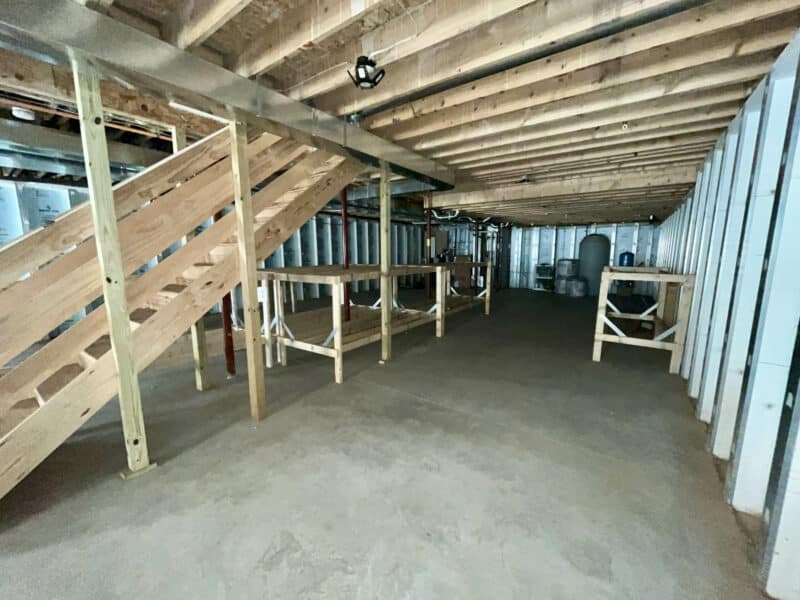 Basement view with framed walls, concrete floor, and open layout.
