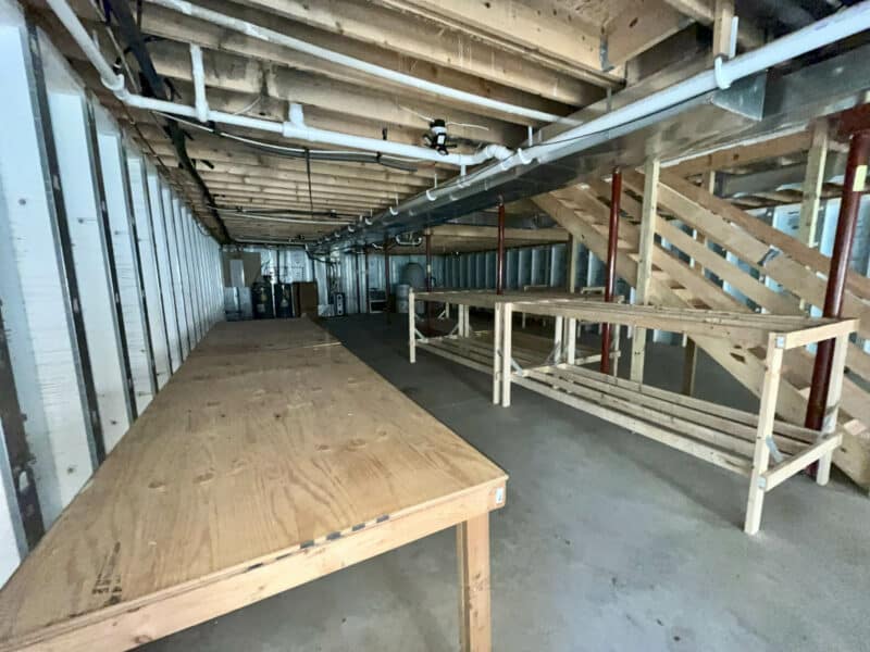 Basement with built-in workbenches and storage area.