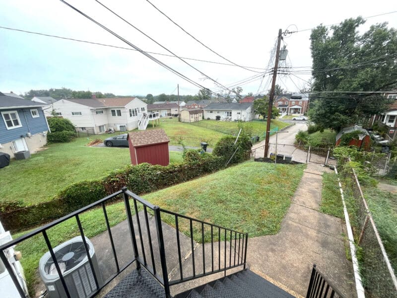 Rear yard with fencing and open green space at 1000 Downton Road.