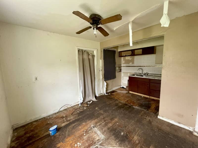 Eat-in kitchen at 4902 Gilray Drive featuring partial cabinetry, ceiling fan, and damaged flooring.