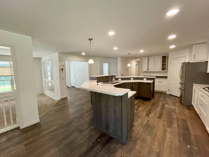 Open-concept kitchen with central island and hardwood-style floors.