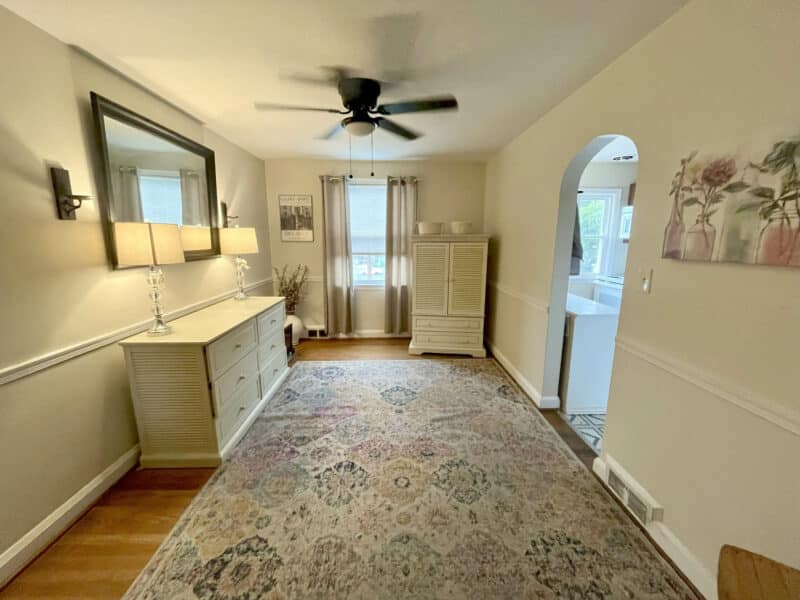 Dining room with wood floors, ceiling fan, and archway to kitchen at 1000 Downton Road in Arbour Manor.