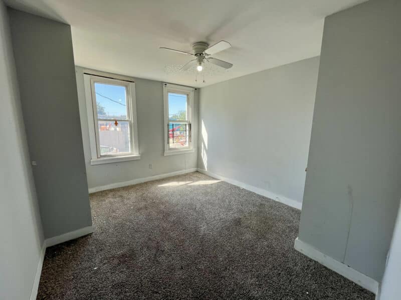 Third bedroom with neutral gray walls, ceiling fan, and carpet flooring at 2115 E. Federal Street, Broadway East, Baltimore.
