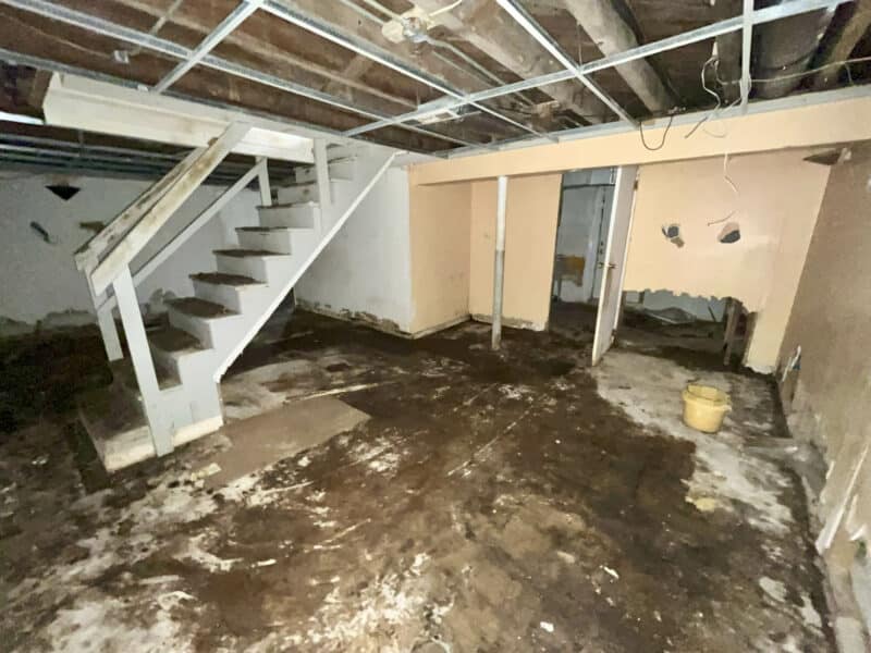 Unfinished basement with exposed ceiling beams and concrete floor at 4902 Gilray Drive.