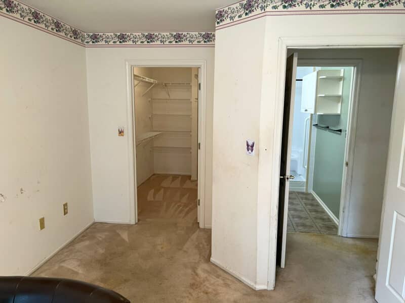 Main bedroom with walk-in closet and en-suite bathroom access in Bel Air condo.