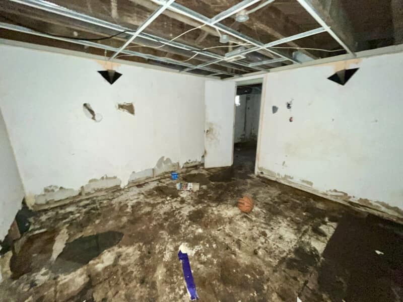 Unfinished basement room with exposed ceiling grid and concrete floor at 4902 Gilray Drive.