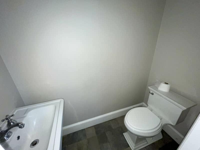 Half bathroom with pedestal sink and toilet