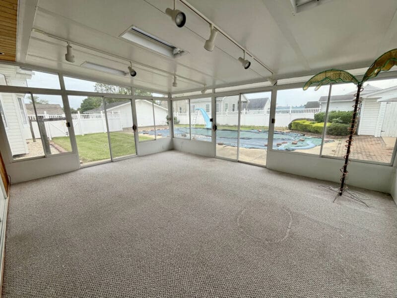 Sunroom overlooking backyard and pool at Dundalk Farms rancher.