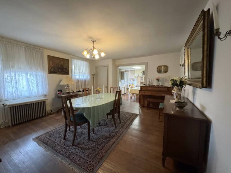 Formal dining room with long table, chairs, and buffet