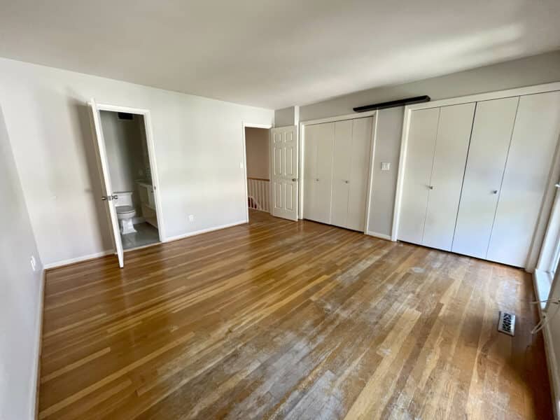 Bedroom with hardwood floors and double closets
