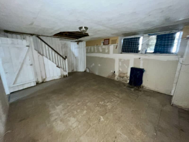 Basement clubroom with partial paneling and tile flooring.