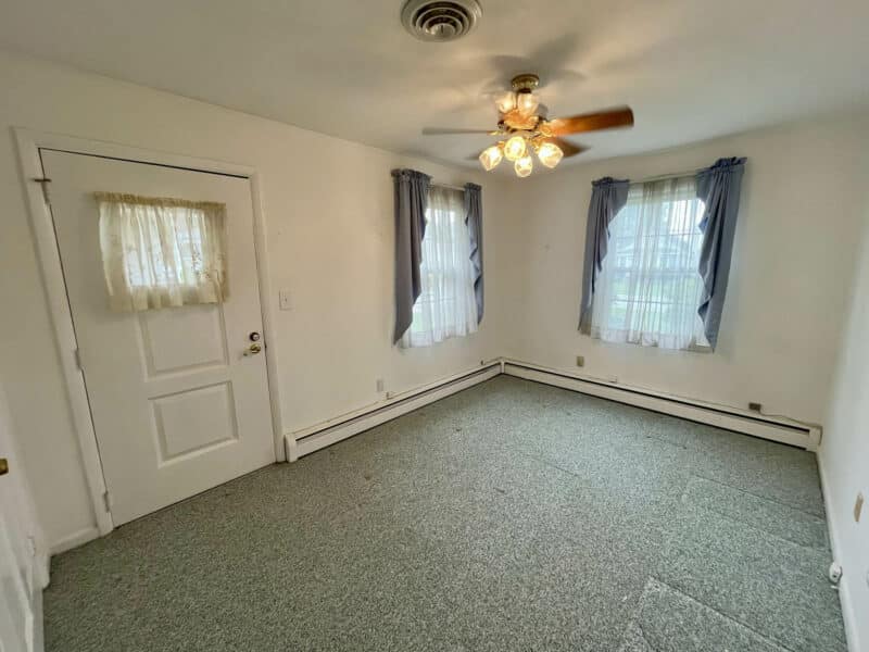 Bedroom or office with outside door and windows in Dundalk Farms home.