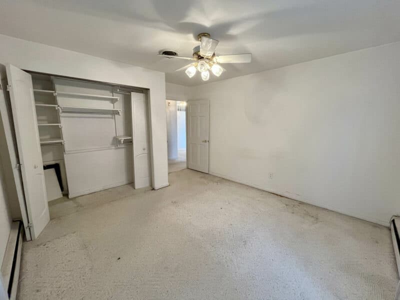Bedroom with carpet and ceiling fan at 7245 Meadow Lane, Dundalk MD.