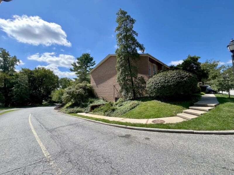 Side view of townhouse condo unit and landscaped lot