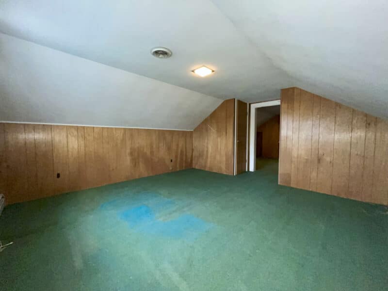 Upper-level den with paneled walls and storage in Dundalk Farms home.