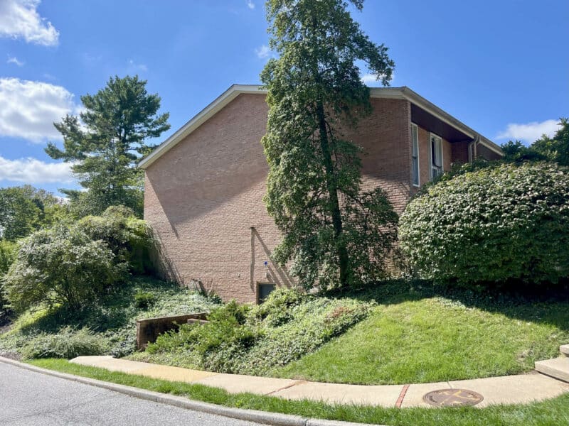 Side view of end-unit townhouse condo with landscaping