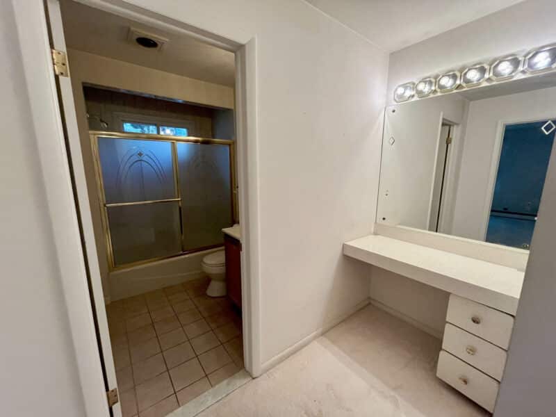 Built-in vanity dressing area next to bathroom in Dundalk Farms rancher.