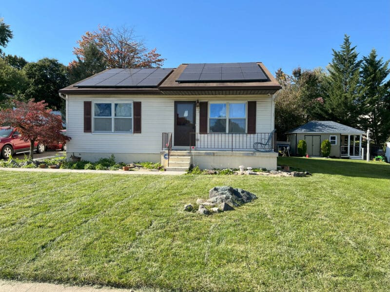 Front exterior view of single-story rancher with solar panels and spacious lawn at 334 Royer Road, Westminster.