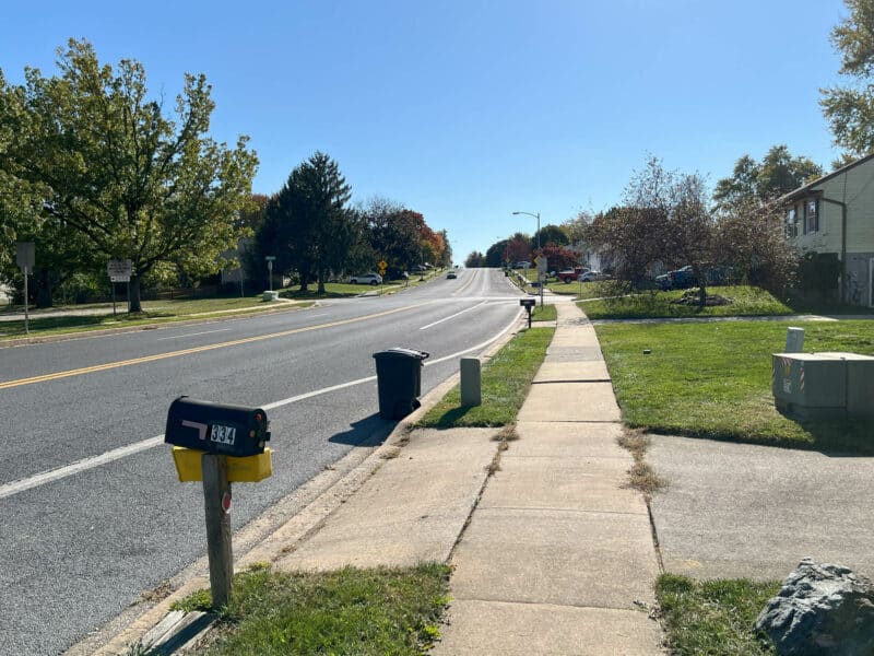 Street view of residential neighborhood at 334 Royer Road in Westminster, showing mailbox, sidewalk, and tree-lined street.