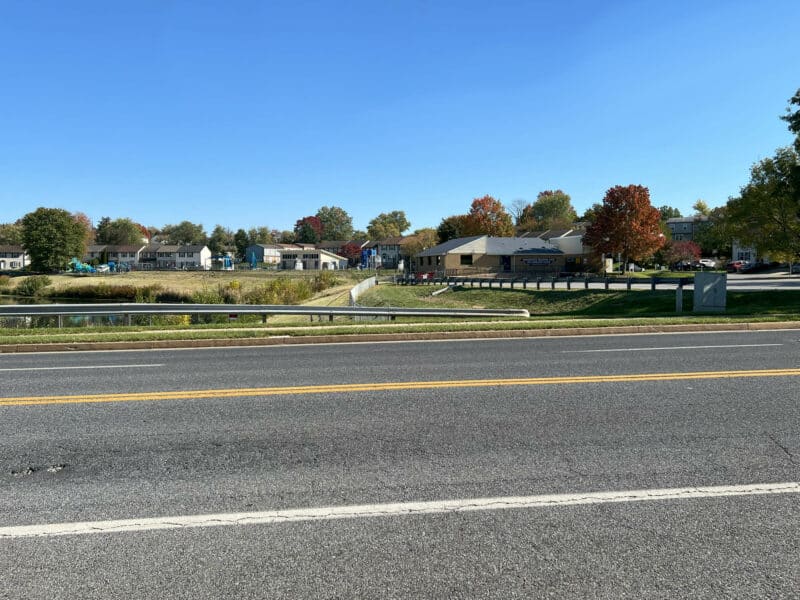 Neighborhood view from the front of 334 Royer Road showing tree-lined street, sidewalks, and nearby homes in Westminster, Maryland.