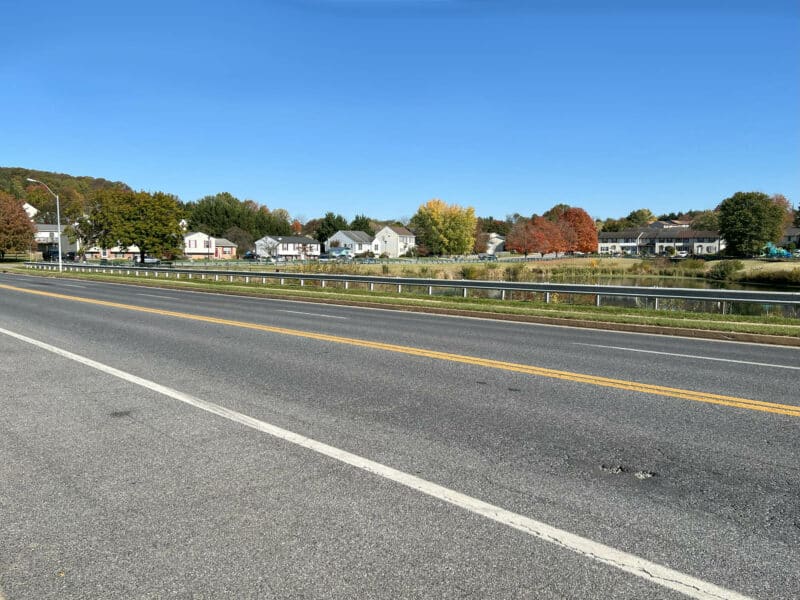 Neighborhood street view from Royer Road showing sidewalk, driveways, and surrounding homes in Westminster, Maryland.
