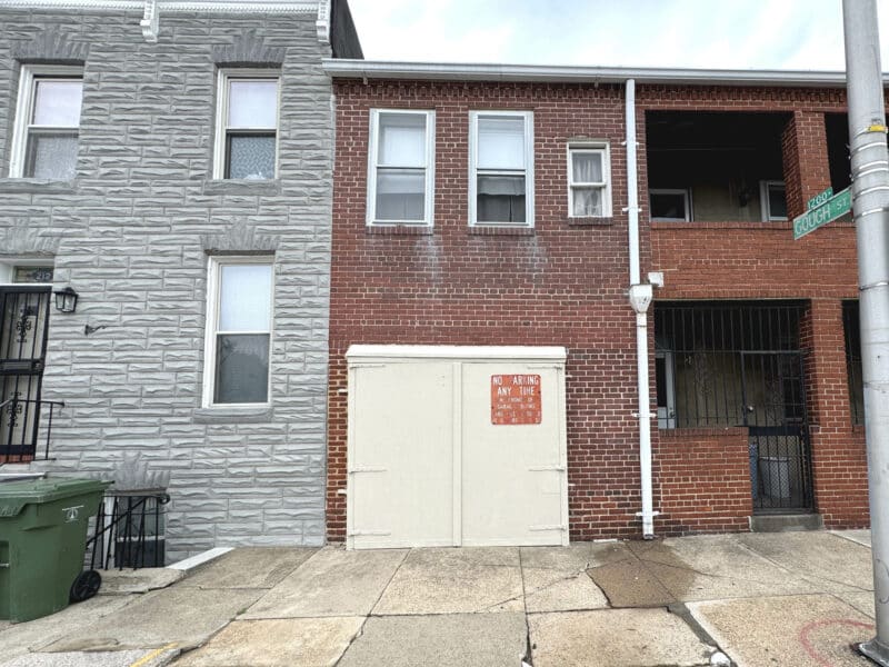 Front view of property with garage door and upper-level windows.