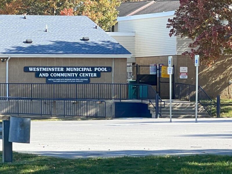 Front view of the Westminster Municipal Pool and Community Center building with signage and entrance steps.