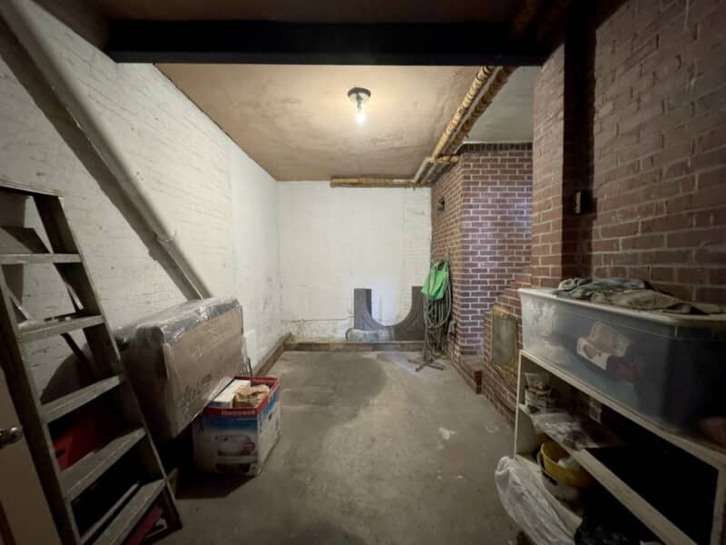 Interior garage space at 1021 Stiles Street with shelving and storage items.