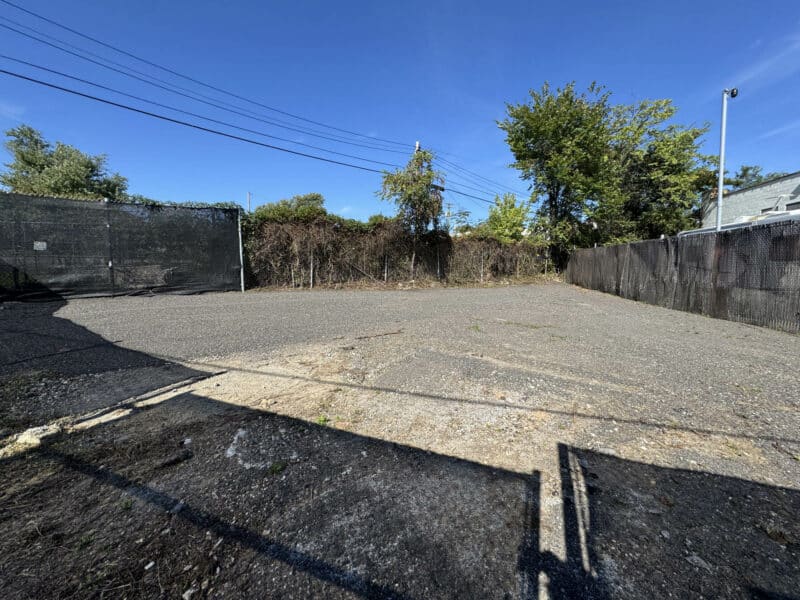 Interior view of fenced industrial storage yard with new gravel and level surface in Morrell Park, Baltimore.