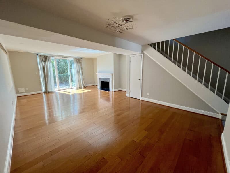 Living room with hardwood floors and staircase