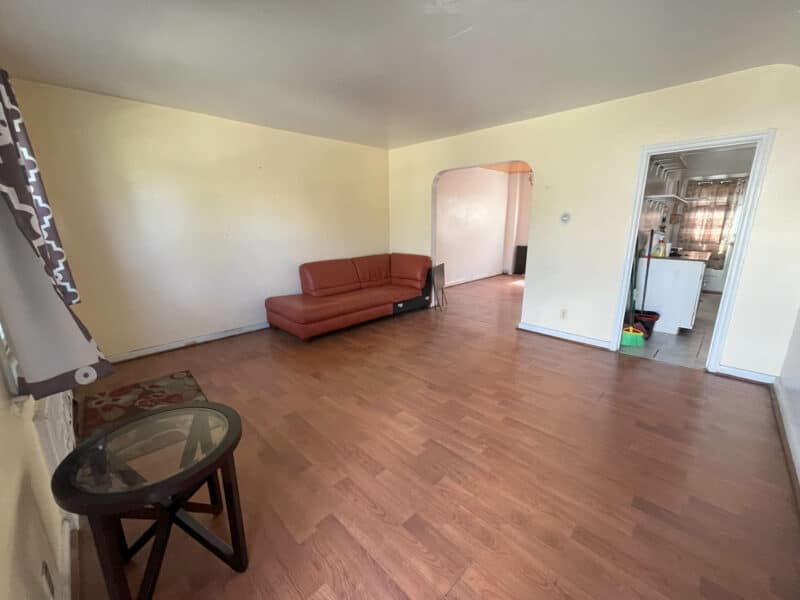 Spacious living room with laminate flooring and yellow-painted walls at 1625 Argonne Drive.