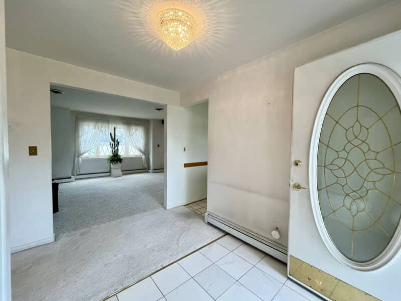 Foyer with tile flooring and coat closet at 7245 Meadow Lane.