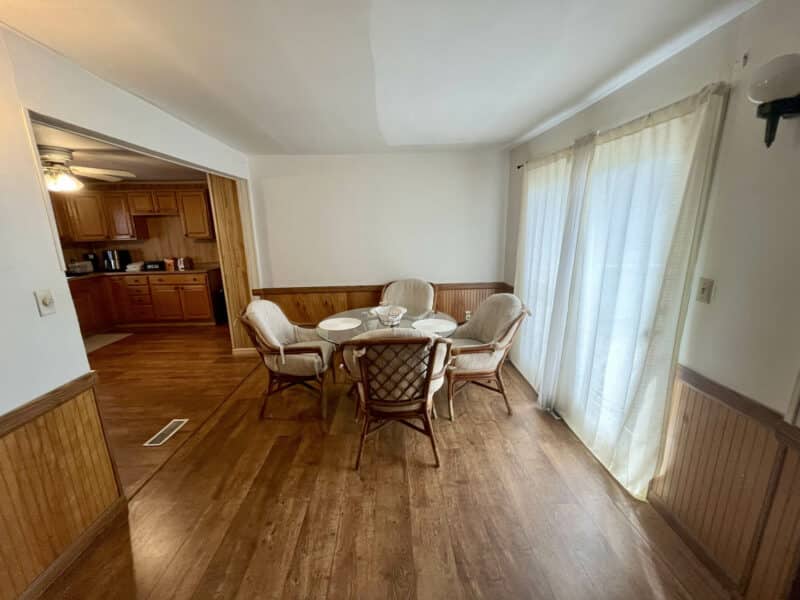Dining area with chair rail paneling and sliding glass doors