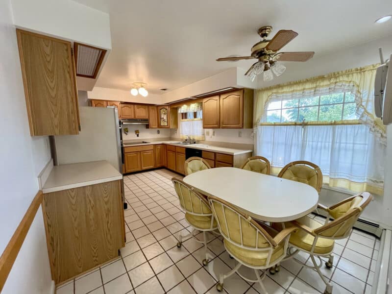 Kitchen with wood cabinets and tile floor at 7245 Meadow Lane, Dundalk MD.