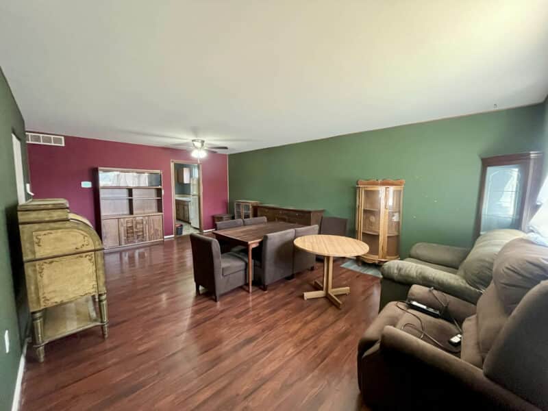 Spacious living and dining room with hardwood floors, accent walls, and flexible layout in Westminster rancher