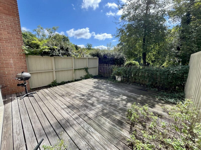 Fenced patio with wooden deck