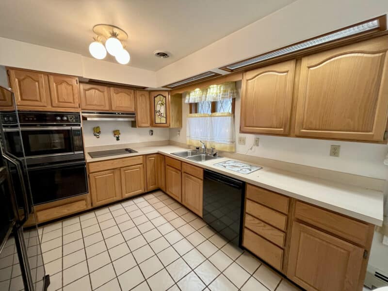 Kitchen with wood cabinets and tile floor at 7245 Meadow Lane, Dundalk MD.