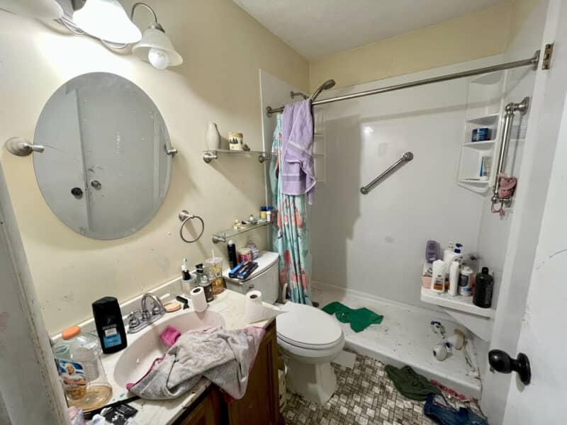 Full bathroom at 2009 Halethorpe Avenue in Halethorpe Terrace, Baltimore County, with single vanity, toilet, and walk-in shower, in need of renovation.