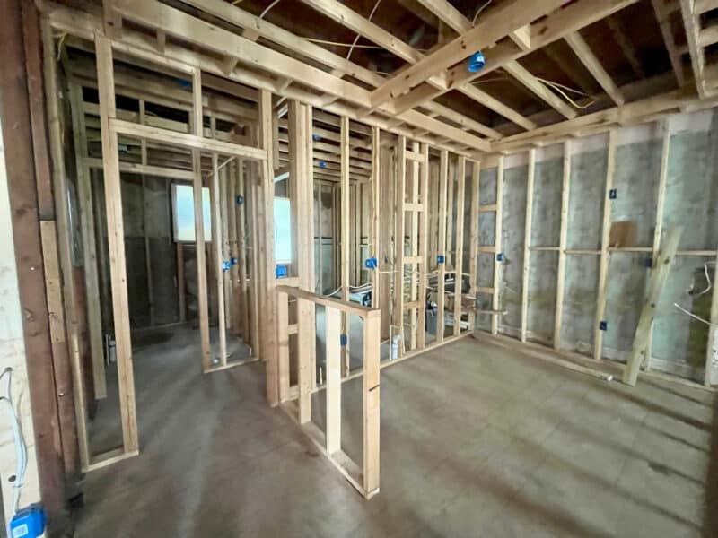 Framed hallway and divider walls with visible outlets and wiring.