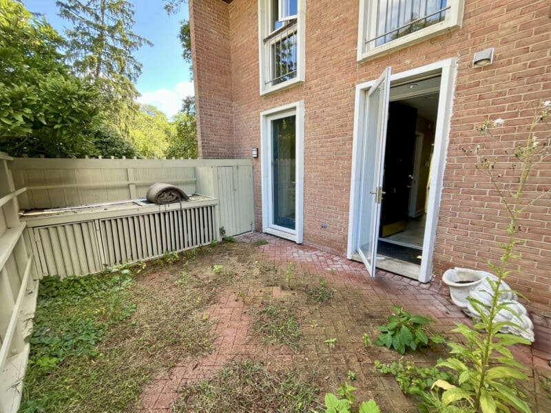 Front fenced patio with brick pavers